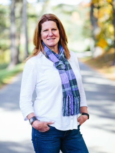 woman wearing a woven plaid scarf