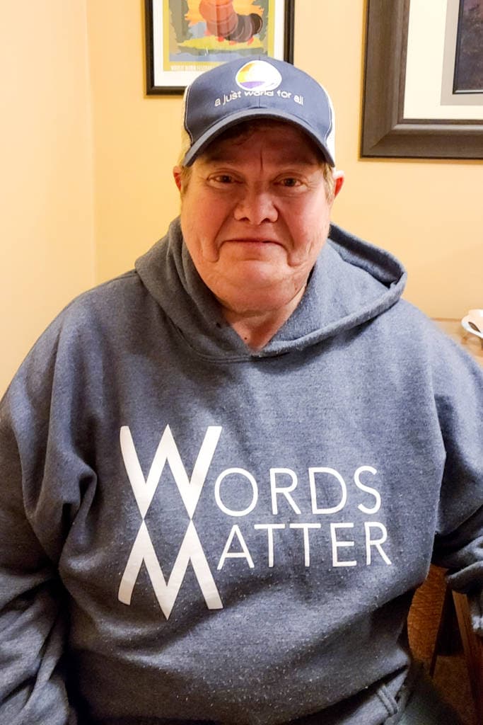 woman with words matter hoodie on facing camera