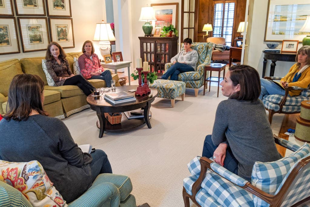 group of ladies sitting around living room talking