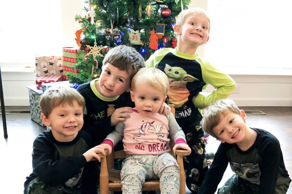 all five martin kids in front of the christmas tree