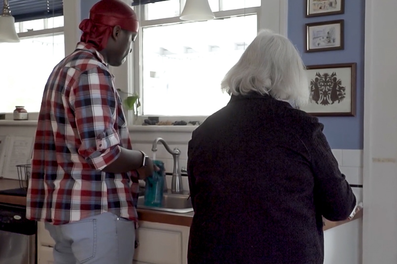 teen washing dishes with foster parent