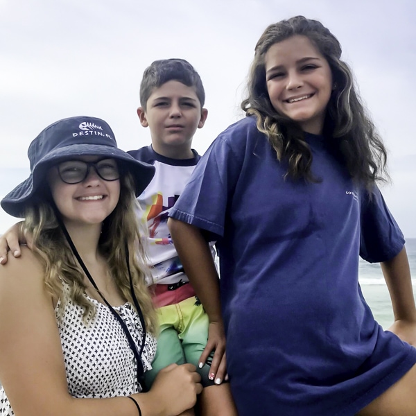 three siblings together on the beach