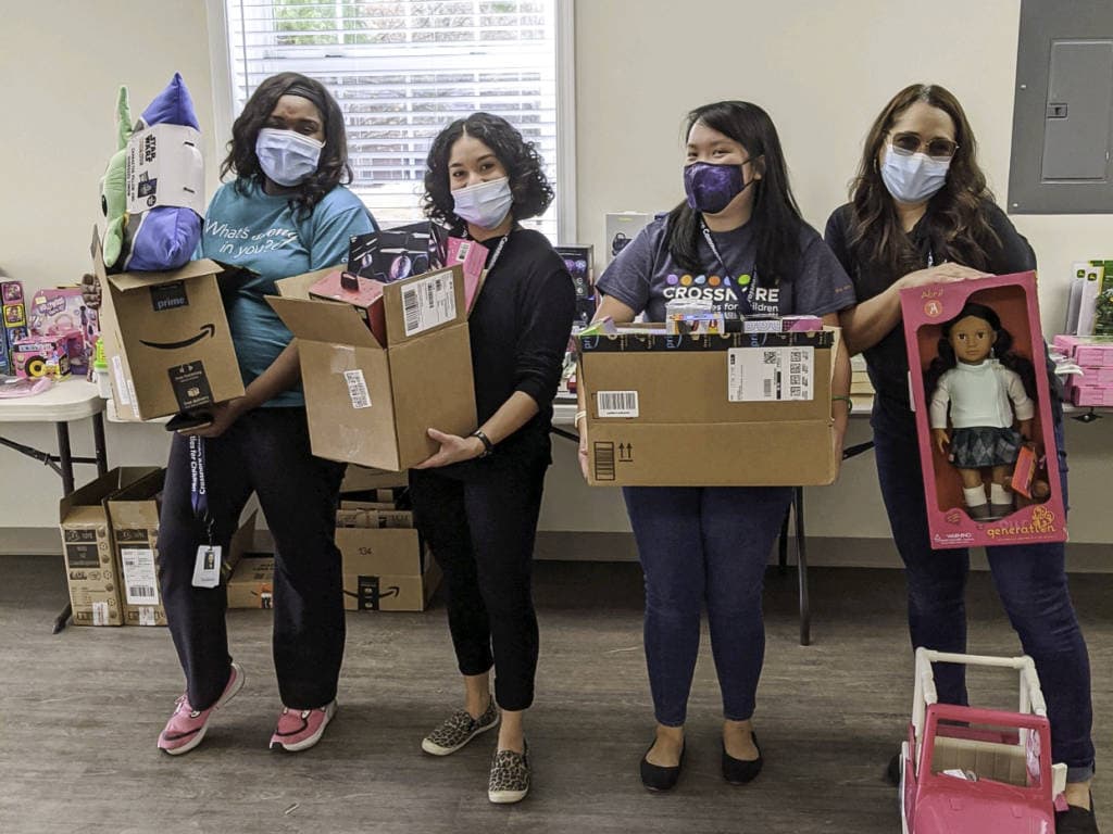 group of crossnore therapists holding gifts picked out for their clients from amazon wish lists