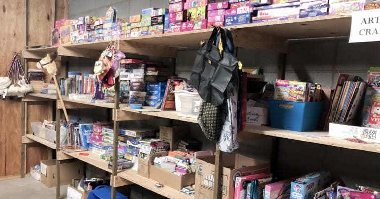 shelves filled with arts and crafts donations
