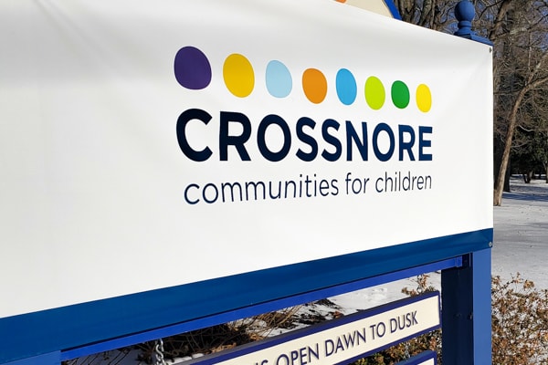 entrance sign with updated crossnore communities for children logo